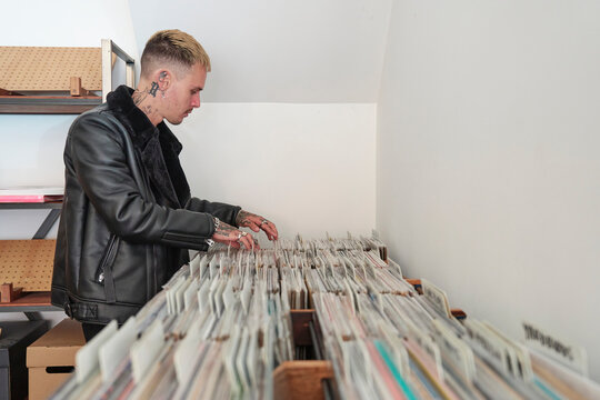 Cool guy sorting through vinyl in record store