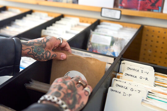 Searching through 7" vinyl records at a music store