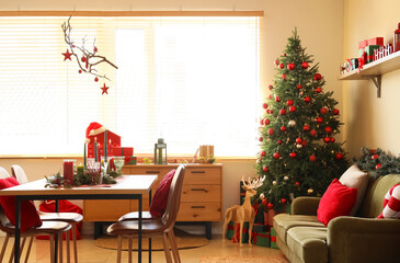 Interior of dining room with table, sofa and Christmas tree