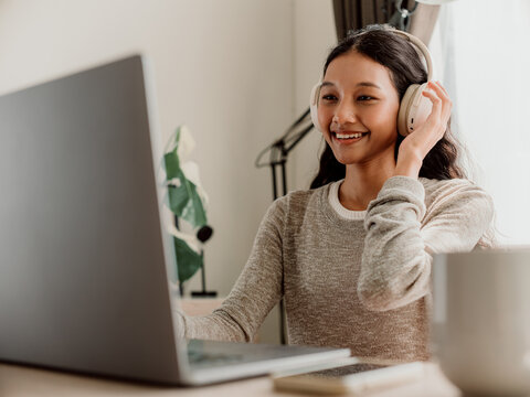 Smiling Woman Using Laptop For Video Call At Home Office