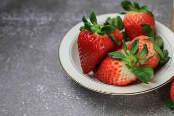 Fresh Strawberries in white bowl. Organic healthy. Summer red fruit with Copy space for text.  