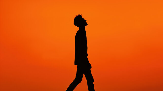 A handsome young man strolls confidently, his silhouette striking against the vibrant skyline, eyes fixed on the horizon.