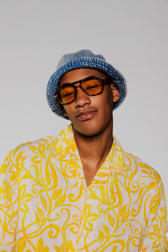 Fashion model posing wearing sunglasses and bucket hat