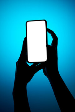 Female hands holding smartphone with white isolated screen mockup