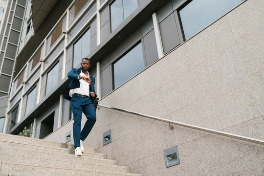 Businessman walking down stairs in a hurry