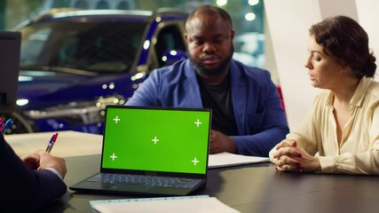 Dealership salesman looking over appointment list on chroma key laptop spreadsheet to schedule car test drive. Showroom agent arranging meeting with clients using isolated screen notebook, camera A