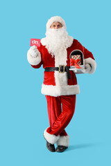 Santa Claus with gift card and mailbox on blue background. Christmas celebration