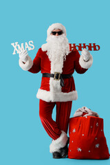 Santa Claus with words XMAS and HOHOHO on blue background. Christmas celebration