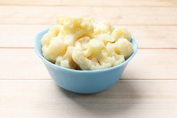 Tasty cooked cauliflower on white wooden table, closeup