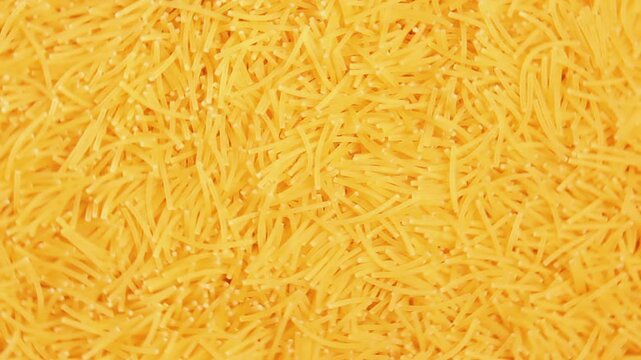 Background of Uncooked Noodles that Rotating Clockwise - Top View, Close-Up. Texture of Dry Vermicelli Turning Around. Raw Pasta - Right Rotation