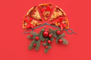 Alarm clock made of pizza and Christmas decor on red background