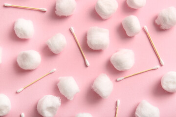 Cotton balls and swabs on pink background