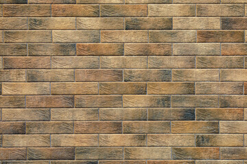 A brick wall with brown and tan bricks
