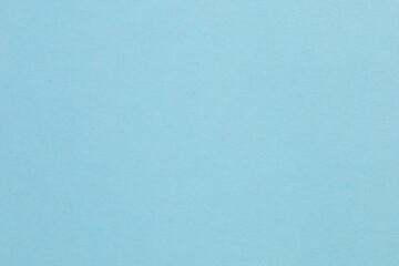 A blue background with a white dot in the middle, textured origami paper backdrop