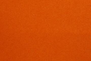 The orange background is a solid color, textured origami paper backdrop