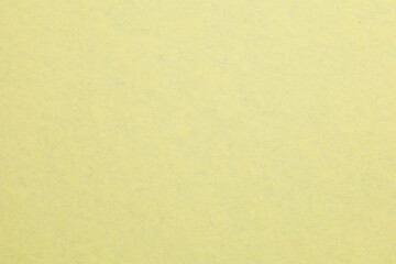 A yellow background with a white object in the middle, textured origami paper backdrop