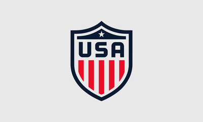 USA shield emblem with red stripes and star.