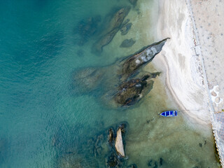 푸른 바닷물과 갯바위 그리고 한척의 작은 배, 
