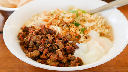 Bubur Ayam: Chicken rice porridge, served with soy sauce, crispy crackers, and fried shallots.