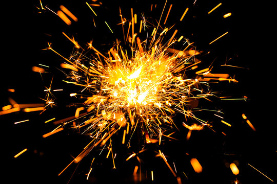 Christmas sparkles on black background. Bengal fire sparkle background. Golden bengal fire sparkle isolated on a black background. New year sparkle on black background.