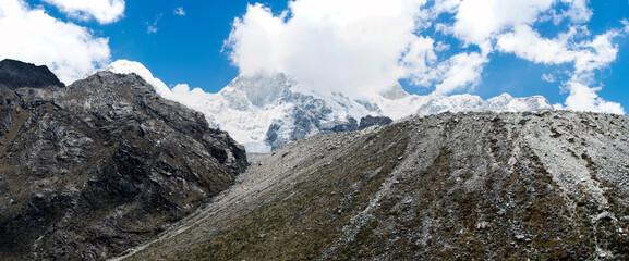 Beautiful snow-capped mountains in the landscape with people climbing to the summit in the Peruvian Andes