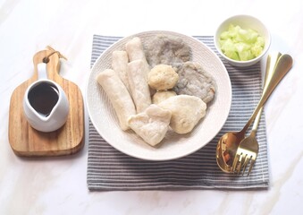 Pempek or empek-empek is a savoury Indonesian fishcake delicacy, made of fish and tapioca, from Palembang, South Sumatera, Indonesia. Pempek is served with rich sweet and sour sauce called cuko