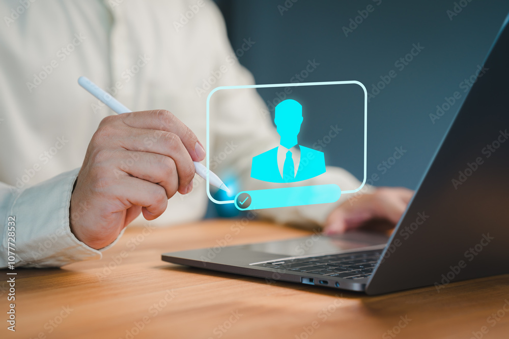 Aufkleber Close-up of a person using a pen to interact with a virtual profile icon on a laptop, representing digital identity verification, login process, or online access authorization.