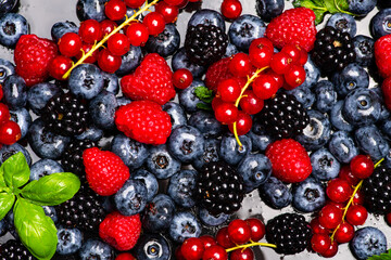 Mix of different berry berries. Berries fruits background. Antioxidants, detox diet, organic berries. Wild berries pattern. Berry background.