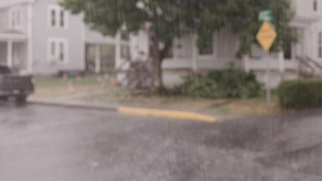 Rainy streets in neighborhood with car going by 4k
