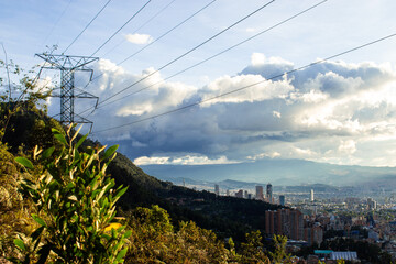 High angle view of Bogota city landscape with electricity tower at sunset, view from mountains