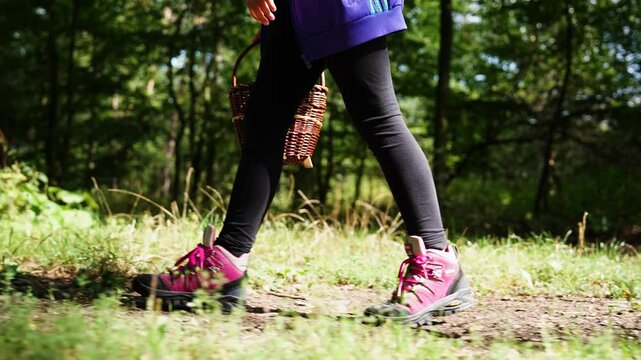 Girl wear pink boots and black leggings walk in countryside forest, Czechia