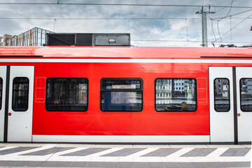 A German S-Bahn train at a suburban station platform, highlighting the efficient commuter rail system connecting suburbs with cities in Germany capturing daily transportation in European urban areas.
