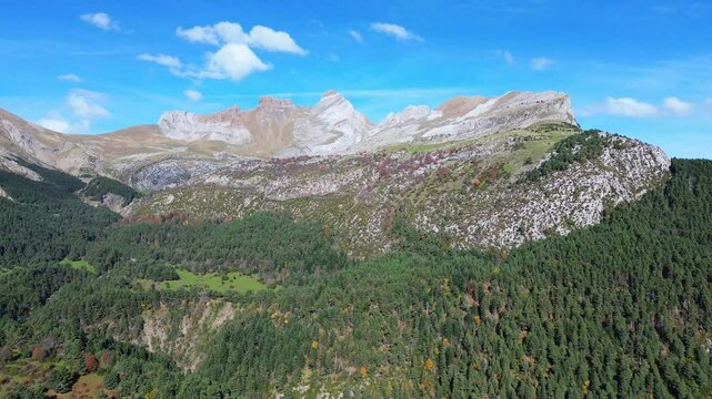 Majada de gabardito with lush forests and rugged mountains under a clear sky, aerial view