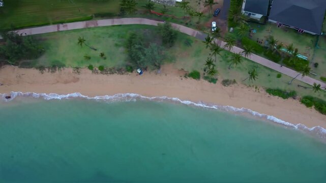Aerial view of Kapaa Beach Park. Top down View of kappa beach in Kauai Hawaii. Cinematic Aerial Hawaiian beach with turquoise blue water