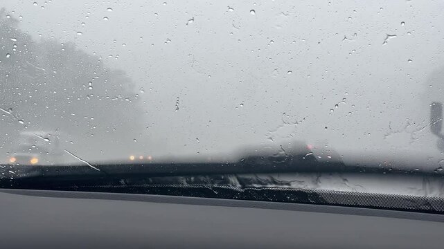 Rain hitting windshield of vehicle while driving down highway 4k
