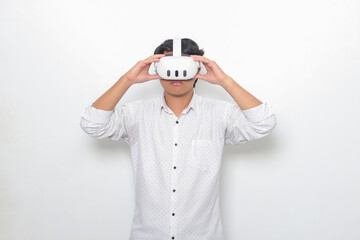 Portrait of Asian man using virtual reality VR device, experiencing immersive technology. Isolated image on white background