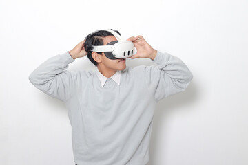 Portrait of Asian man using virtual reality VR device, experiencing immersive technology. Isolated image on white background