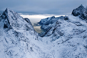 Majestic, towering, snowcapped mountains stand proudly beneath a dramatic and vivid sky