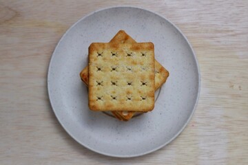 Square Salt Crackers, Close-up view of crispy crackers. served on a plate top view
