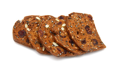 Baked crisps with cranberries, nuts and seeds stacked on a white background