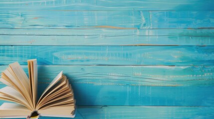 Open Book on a Blue Wooden Background