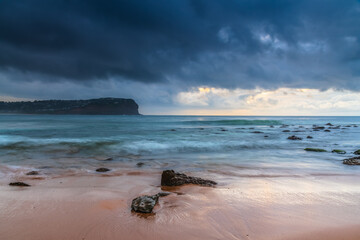 Cloud covered sunrise at the seaside