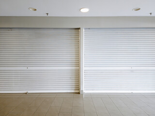 Steel shutter doors of warehouse, storage or storefront for closed gray metal door background and...