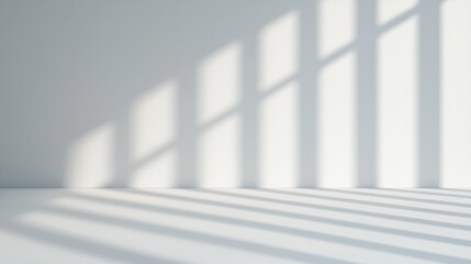 Obraz premium Soft shadows cast by vertical blinds on a white wall create a calming, minimalistic pattern in a serene, light-filled space.