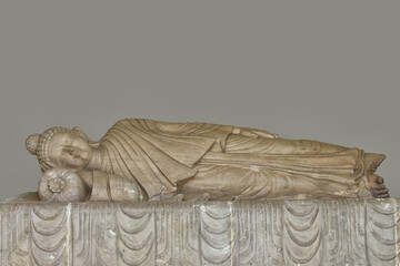 A serene statue in a peaceful sleeping position, a symbol of tranquility and contemplation.