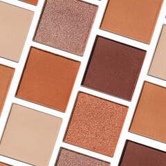 Fototapeta premium Cosmetics texture pattern, makeup palette vivid neutral color eye shadow, square eye powder swatches. Female cosmetic and beauty products, aesthetic minimal beauty photo, colorful eyeshade top view