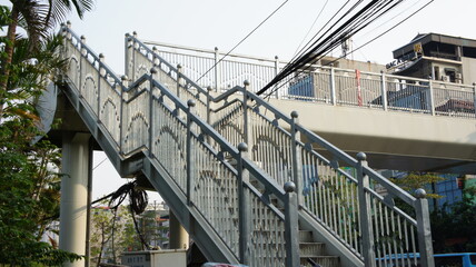 Pedestrian bridge with metal railings and stairs