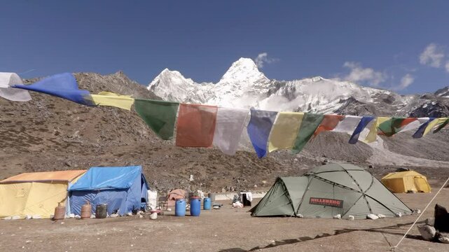 Ama Dablam basecamp with prayer flags waving in the wind