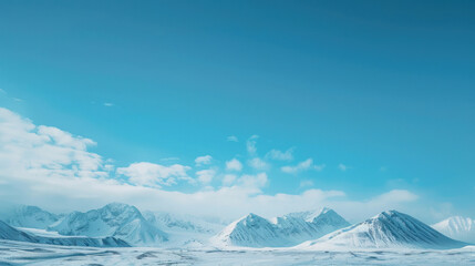 Obraz premium Blue sky fading into a distant horizon of snowy mountain peaks, the air crisp and clear