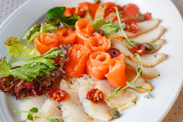 Close-up of healthy omega 3 rich salad with salmon, tomatoes and leaves